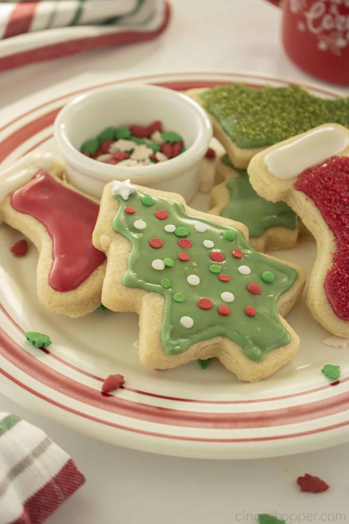 Decorated Christmas No Chill Sugar Cookies on a plate with icing on top.