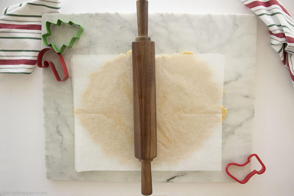 Rolled cookie dough in between two pieces of parchment paper.