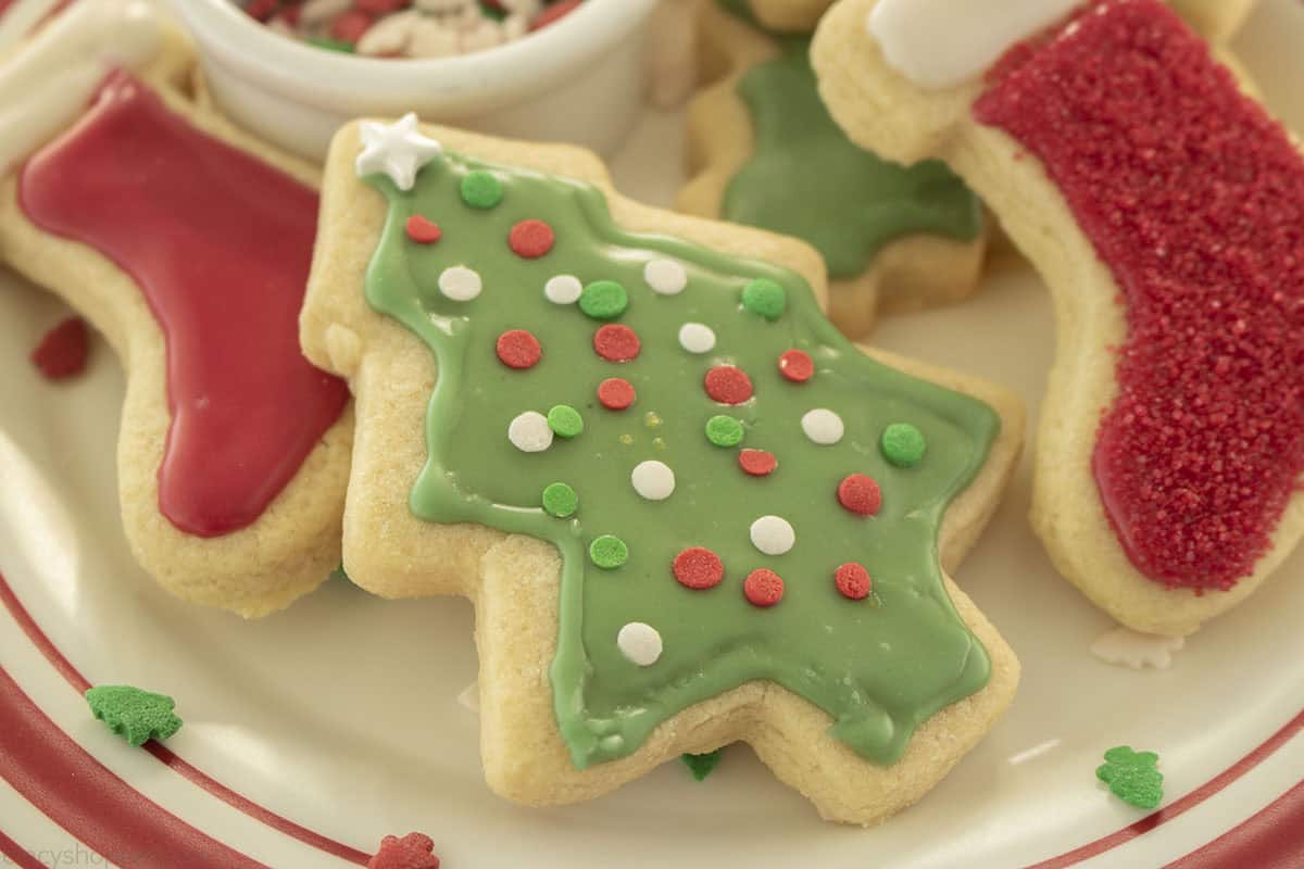 Baked and decorated Christmas sugar cookies on a plate.