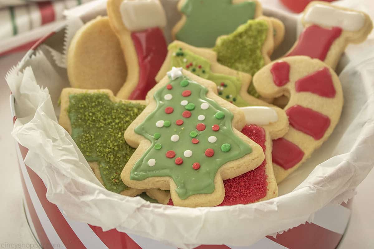 Finished Sugar cookies for Christmas in a red and white cookie tin.