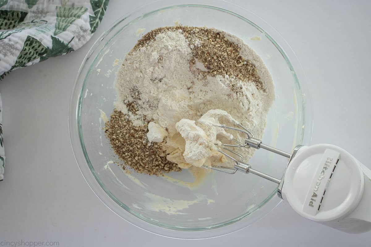 Flour and crushed pecans added to butter mixture.