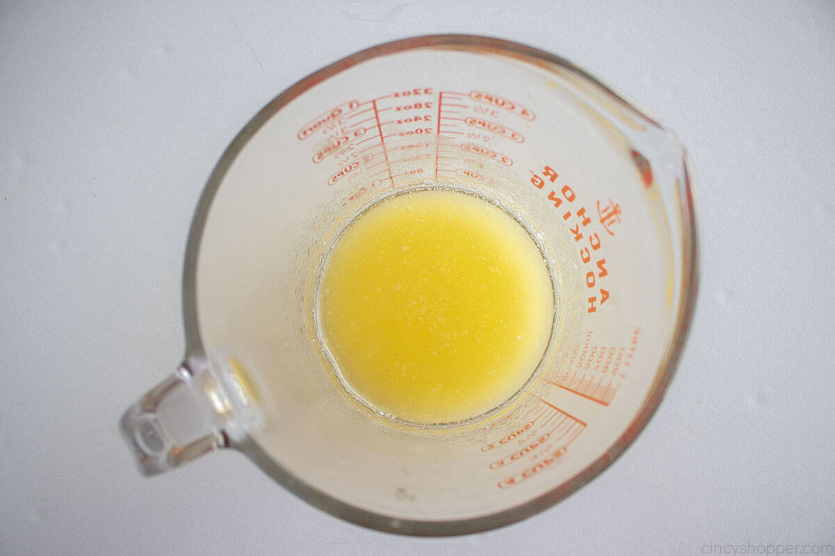 Melted butter in a glass measuring cup.