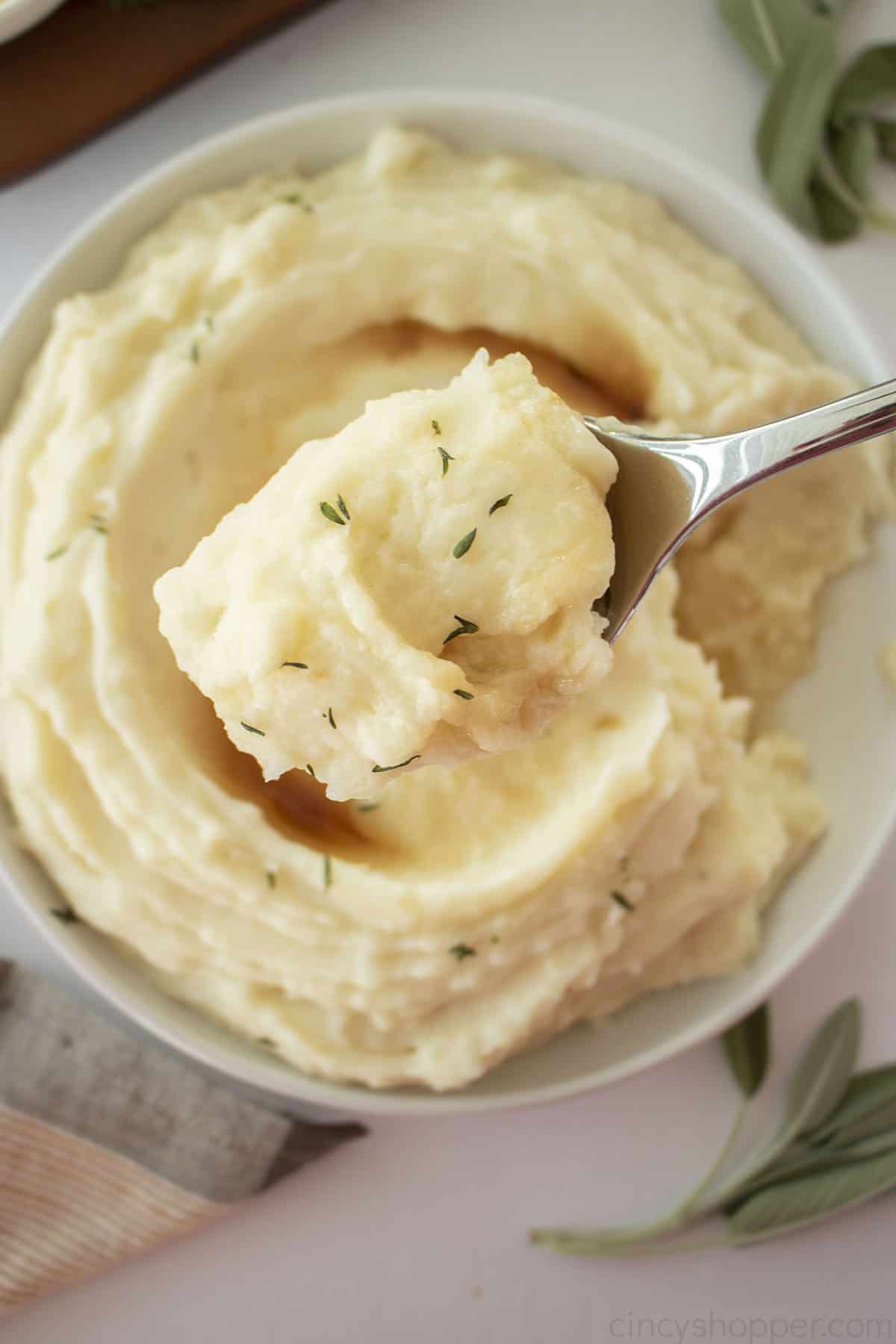 Garlic and herb mashed potatoes on a spoon.