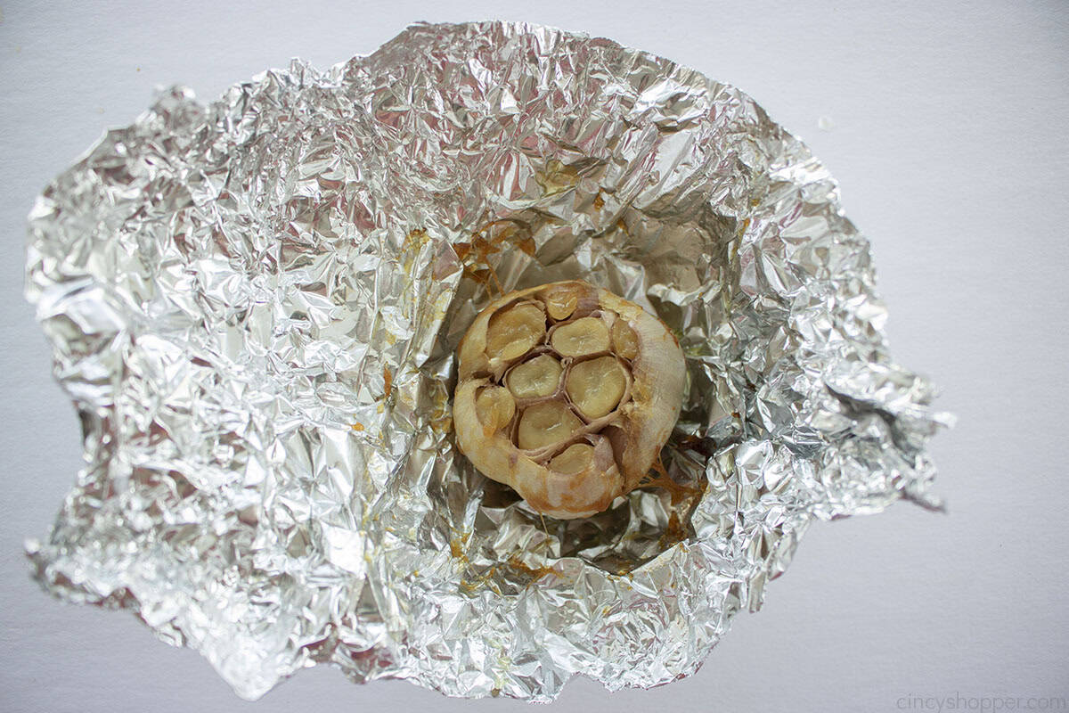Freshly roasted garlic inside of a piece of aluminum foil.