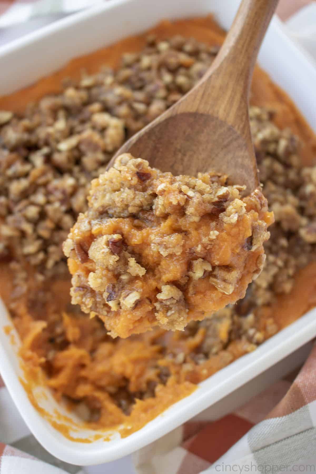 Ruth's Chris Sweet Potato Casserole on a wooden spoon.