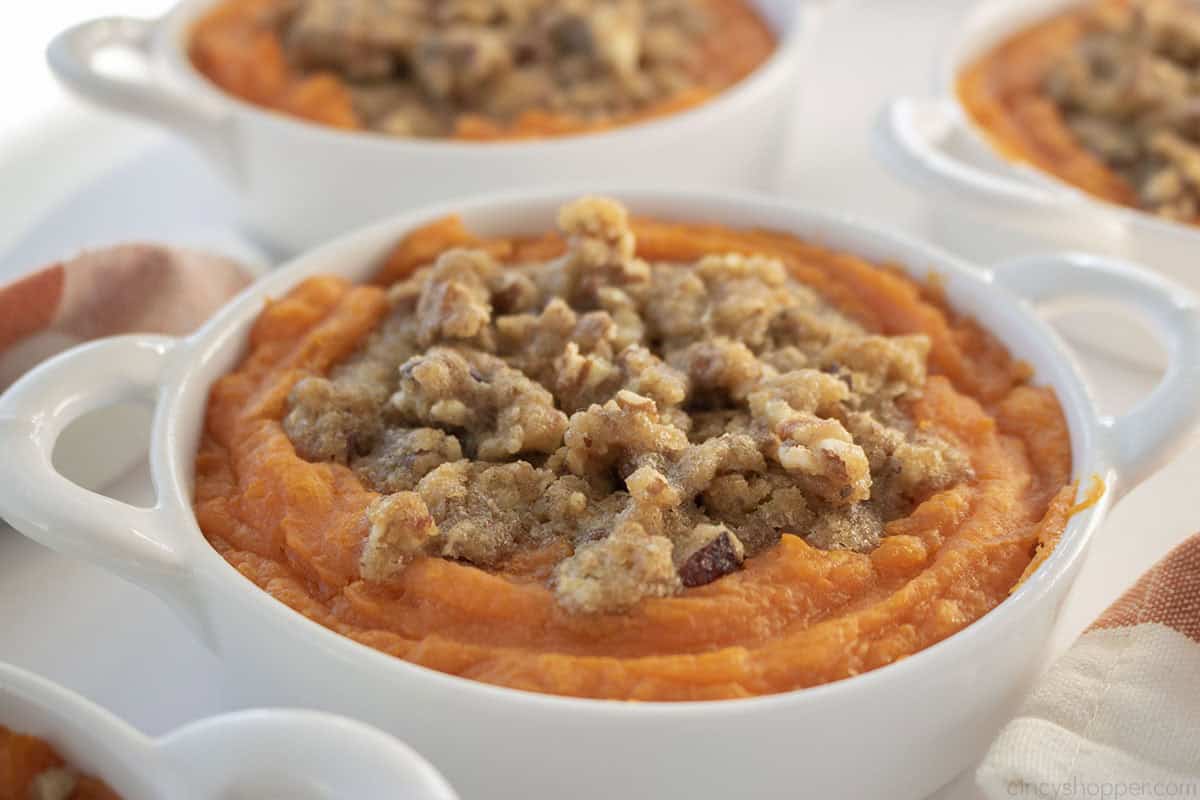 Individual sweet potato casseroles with pecan topping.