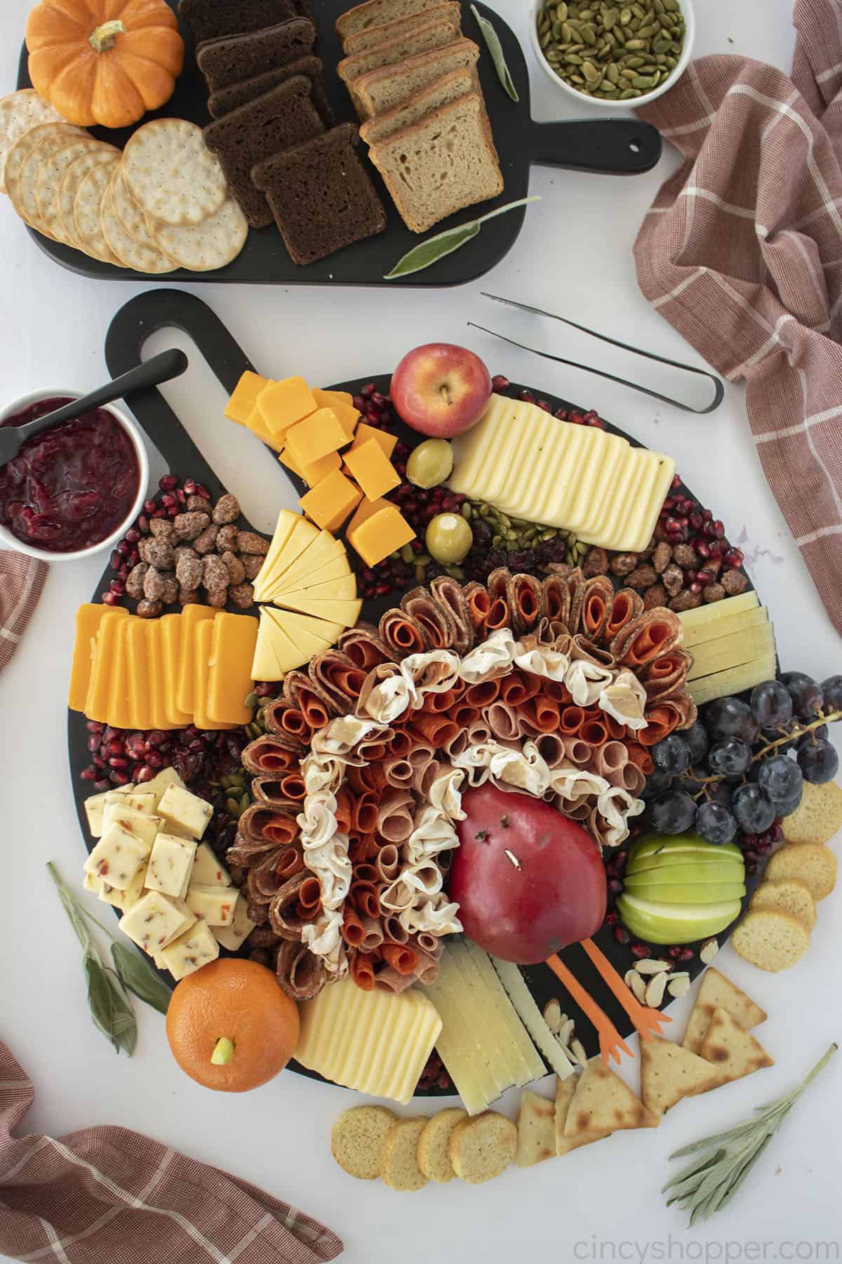 Thanksgiving Charcuterie Board with pear shaped turkey, meats, cheeses and fruits.