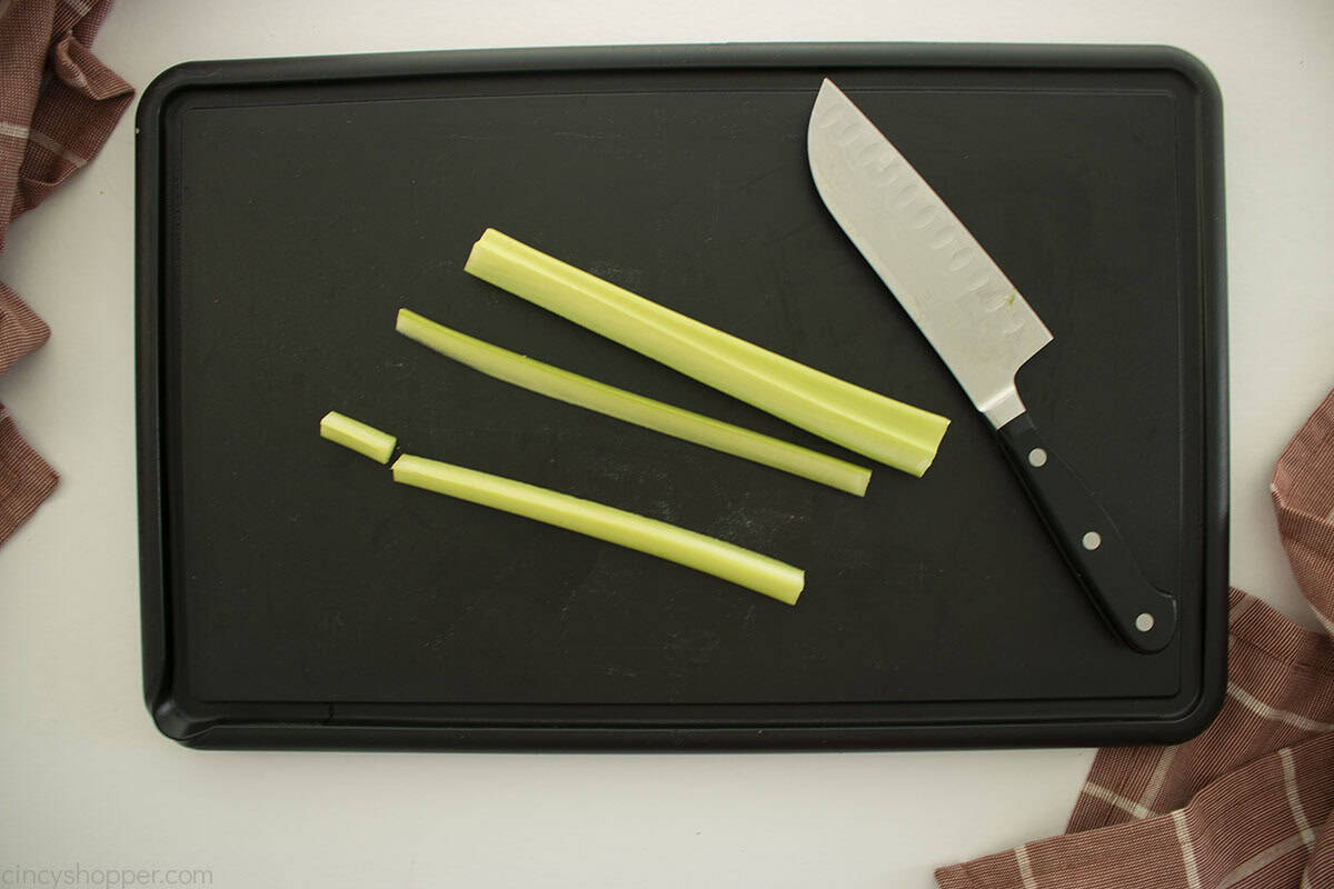 Cut celery sticks with a knife for orange pumpkin stem.