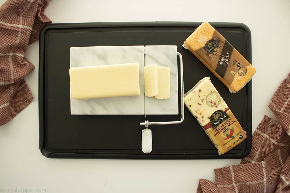 Sliced brick cheeses with cheese slicer.