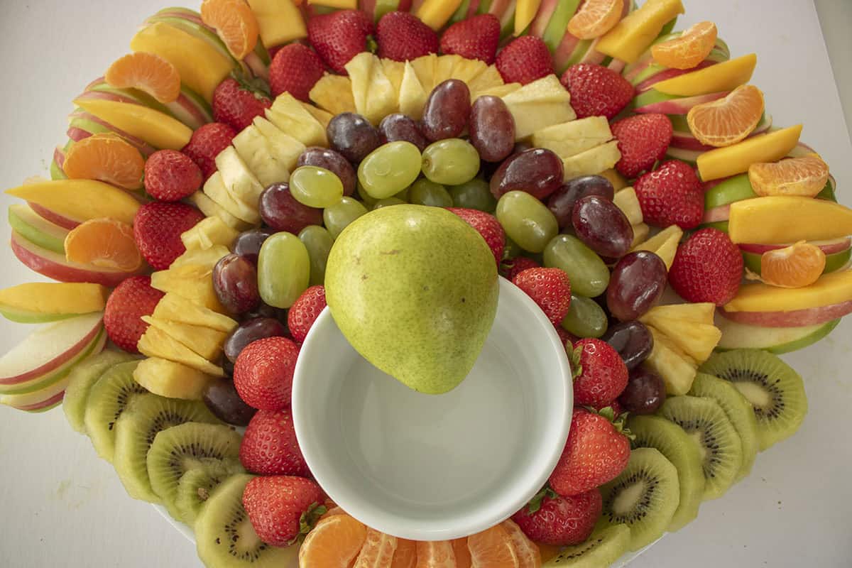 Pear for turkey face placed on bowl.