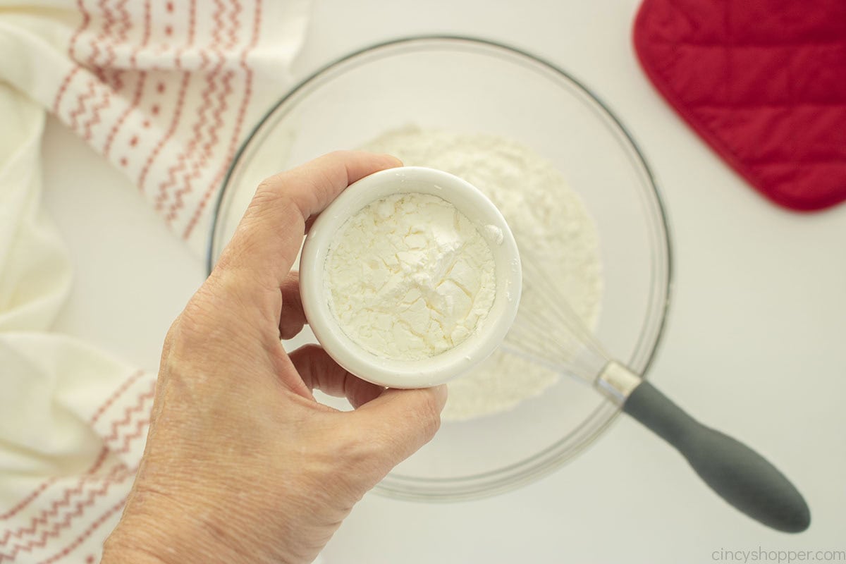 Adding cornstarch to flour bowl.