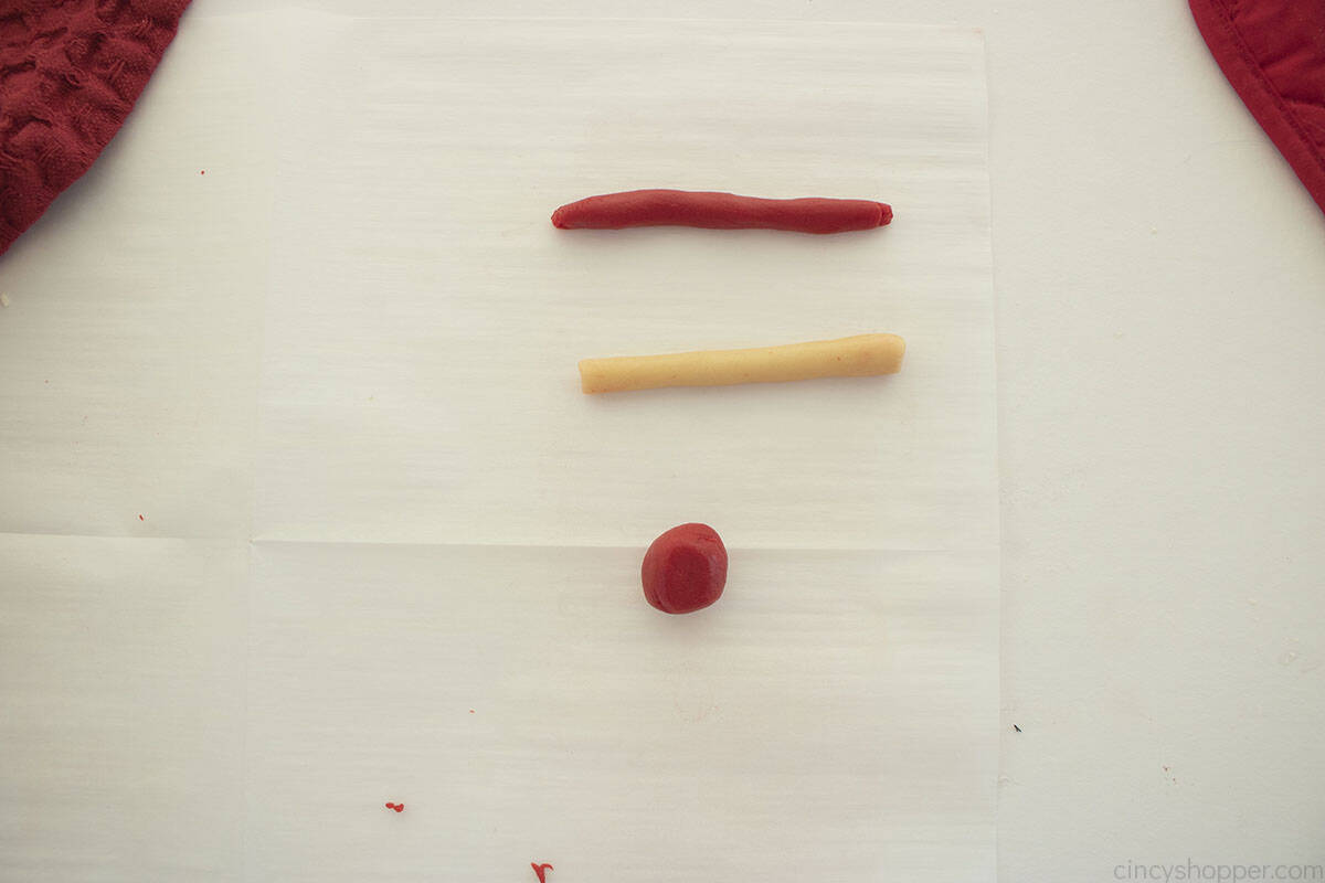 White and Red colored cookie dough shaped into logs