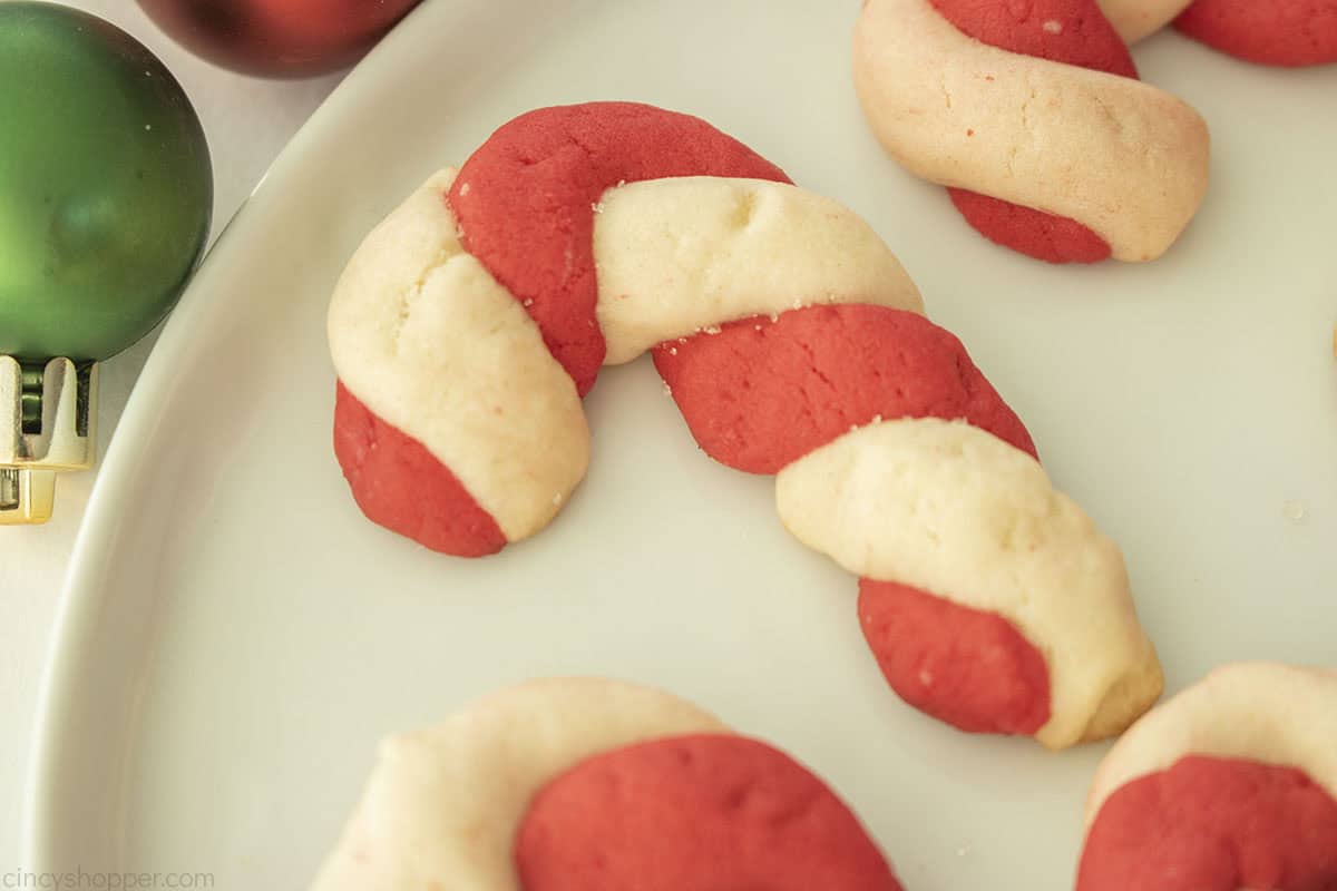 Sideways view of twisted sugar candy cane cookie.