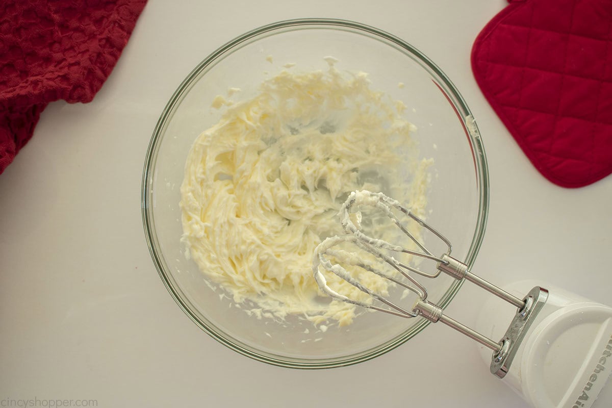 Butter creamed in clear mixing bowl with hand mixer.
