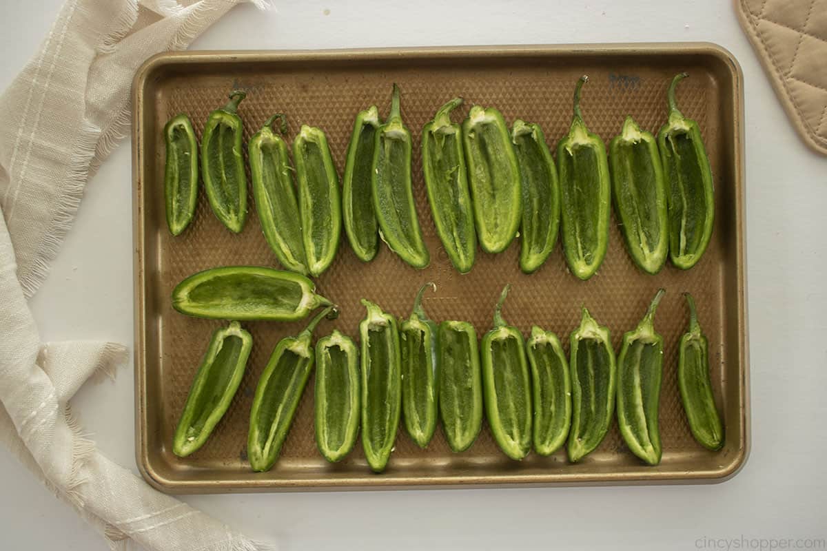 Jalapeno halves on a baking sheet