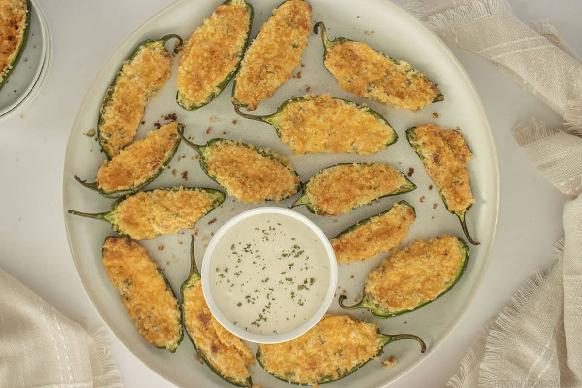 Plate filled with ranch dipping and jalapeno poppers.