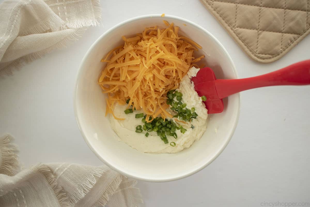 Cheese and green onion added to cream cheese mixture.