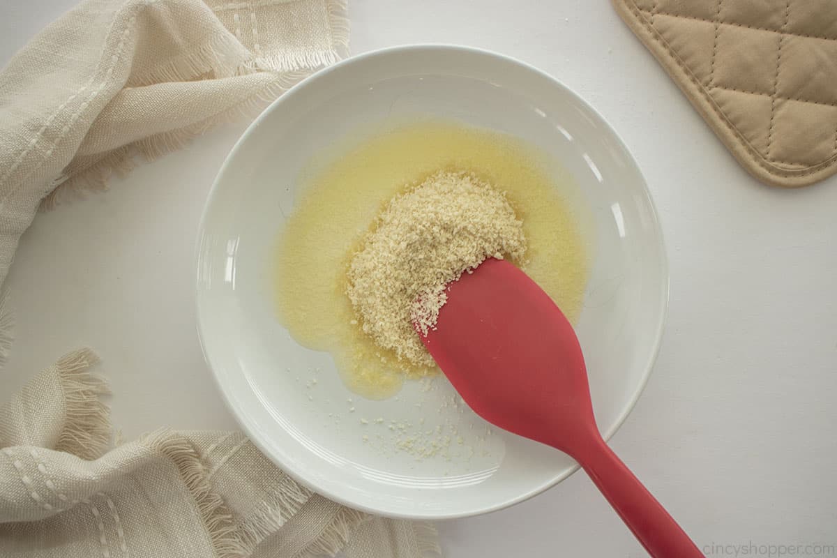 Breadcrumbs in a bowl with melted  butter.