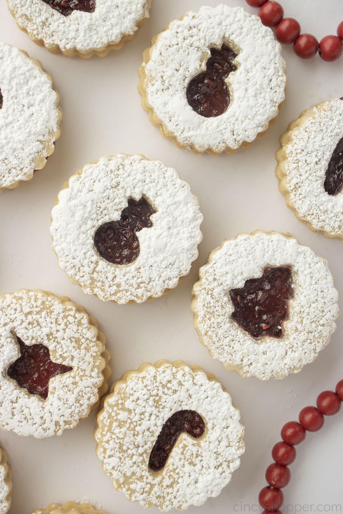 Linzer Cookies with closeup of raspberry jam filling.