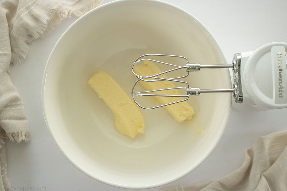 Softened butter in a bowl with a hand mixer.
