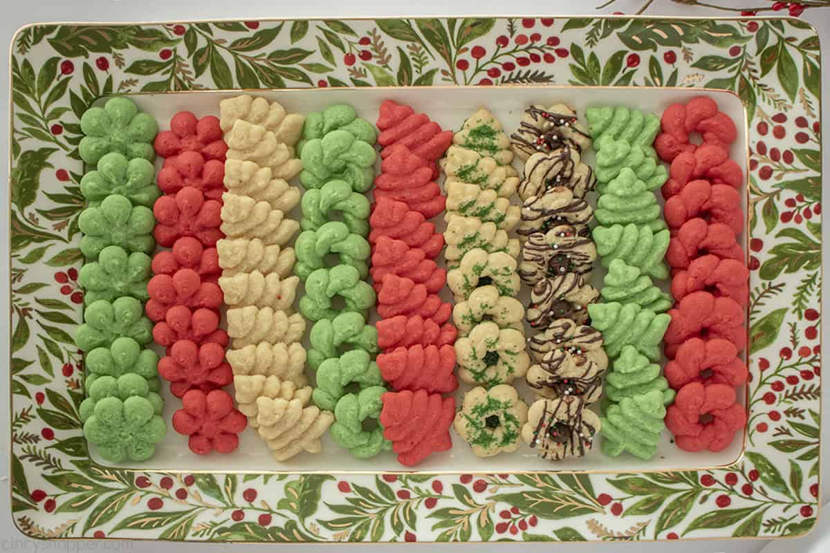 Red, green and white spritz cookies on a Chrismas platter.