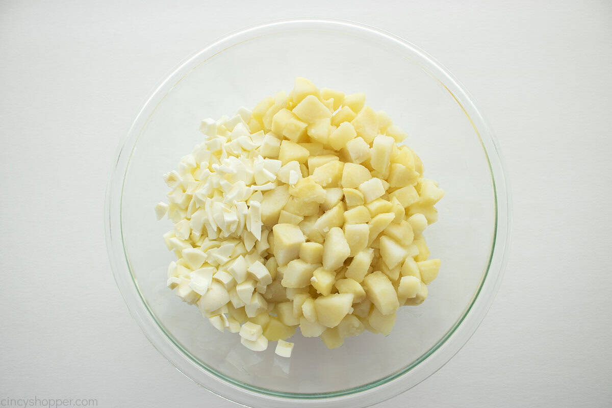 Diced potatoes and diced boiled eggs in a bowl.