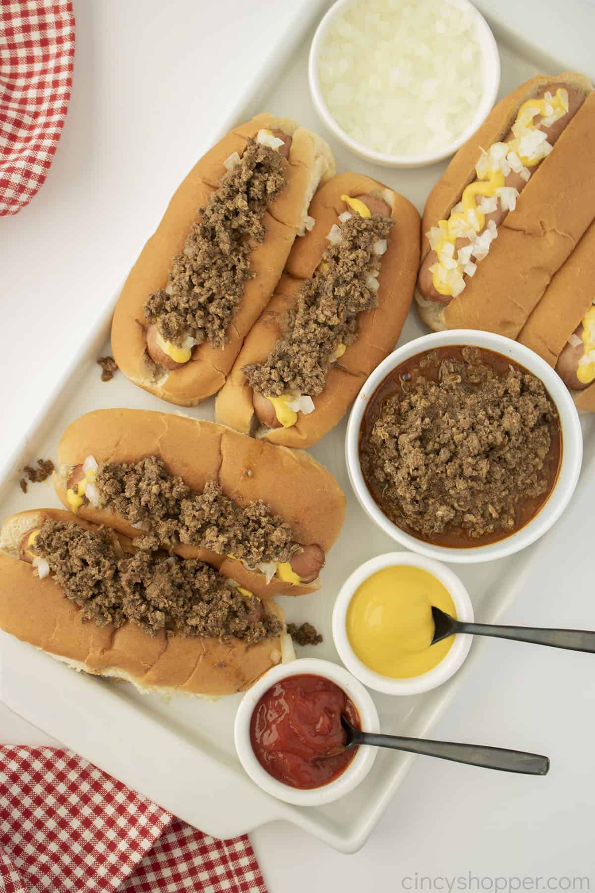 Hot dogs topped with Texas Hots Hot dog Sauce on a platter.