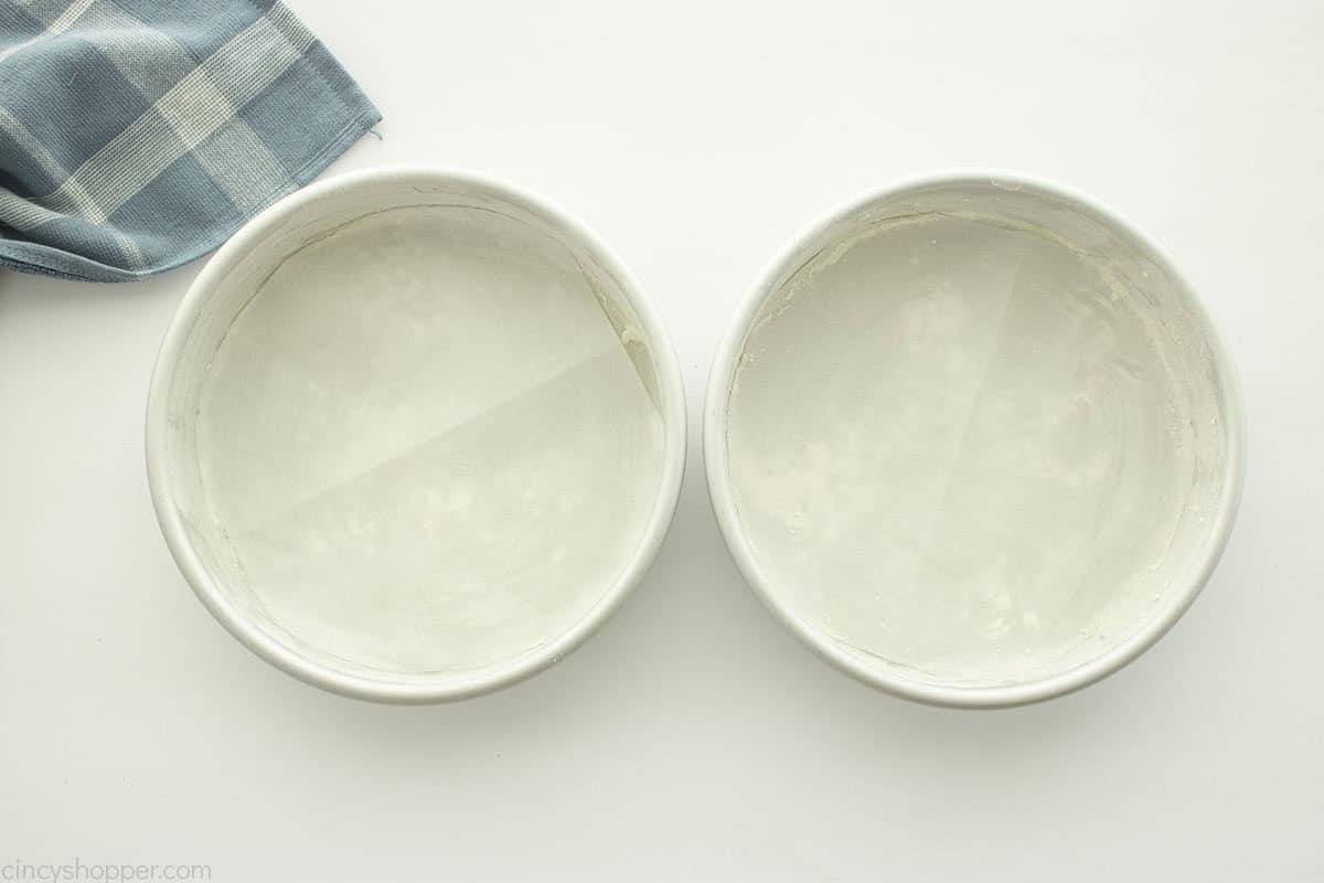 Prepared round cake pans.