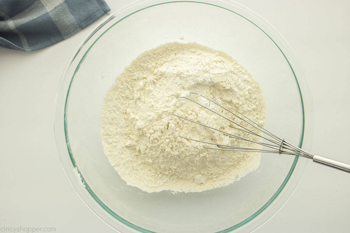 Dry cake ingredients in a clear bowl.