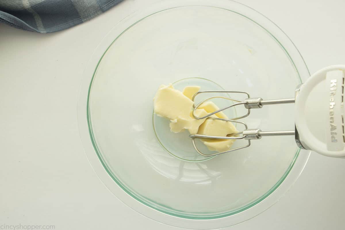 Creaming butter in a clear bowl with hand mixer.