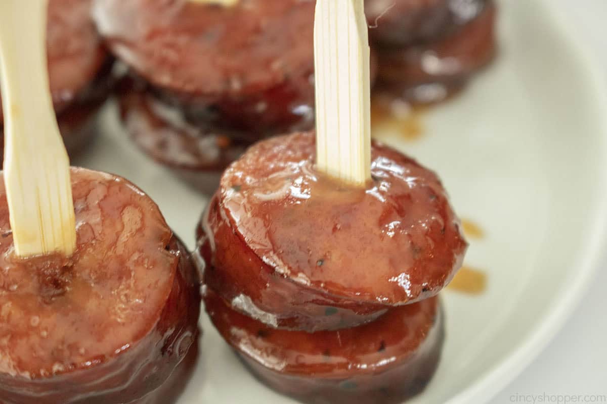 3 Ingredient Brown Sugar Kielbasa Bites on a skewer pick.