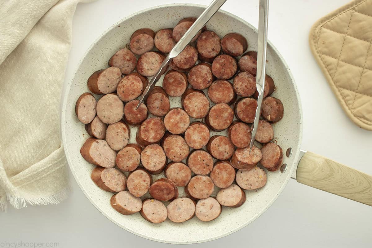 Cooking Kielbasa on a fry pan.