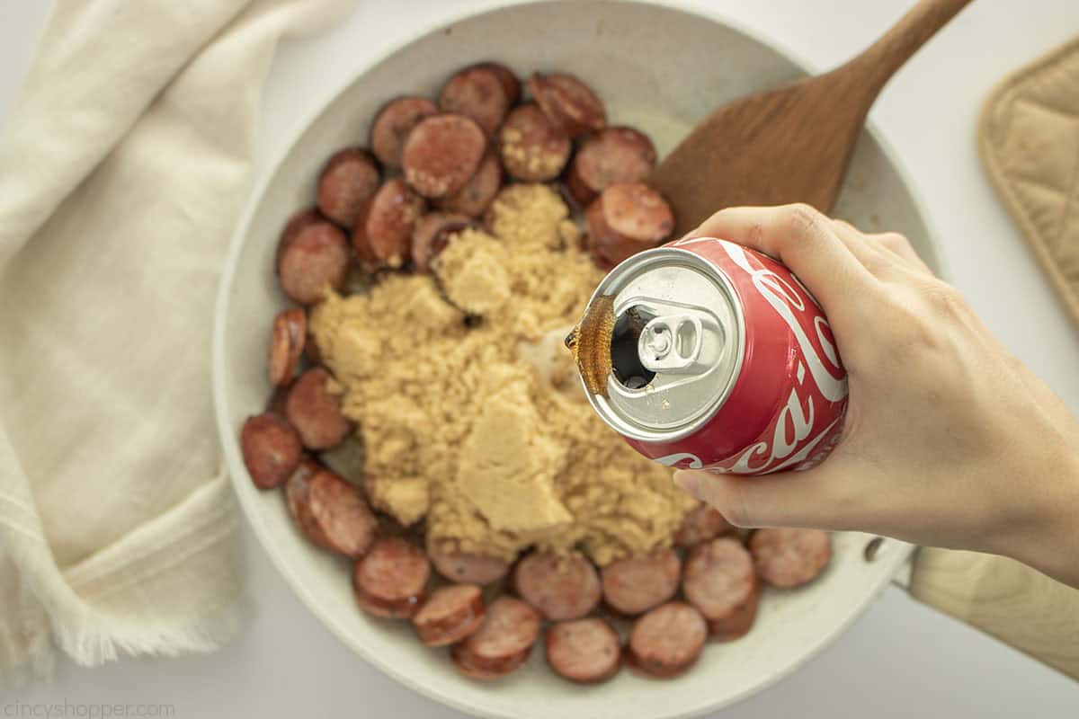 Adding brown sugar and cola to Kielbasa Bites.
