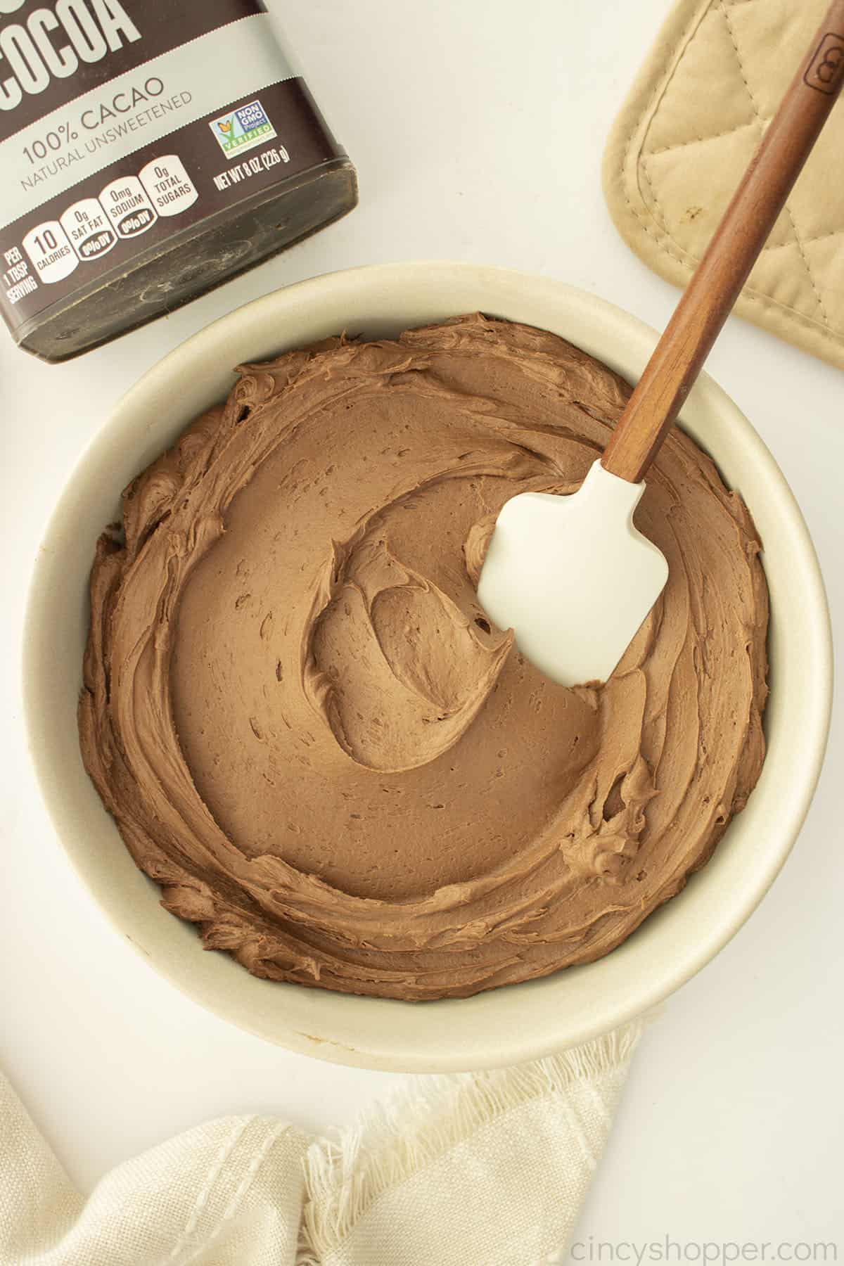 Chocolate Buttercream frosting in. a beige bowl.