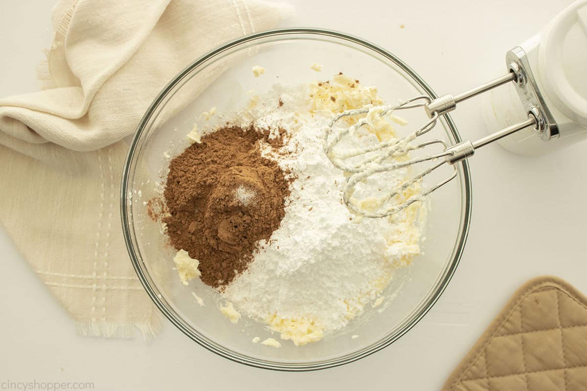 Powdered sugar and cocoa added to buttercream mixture.