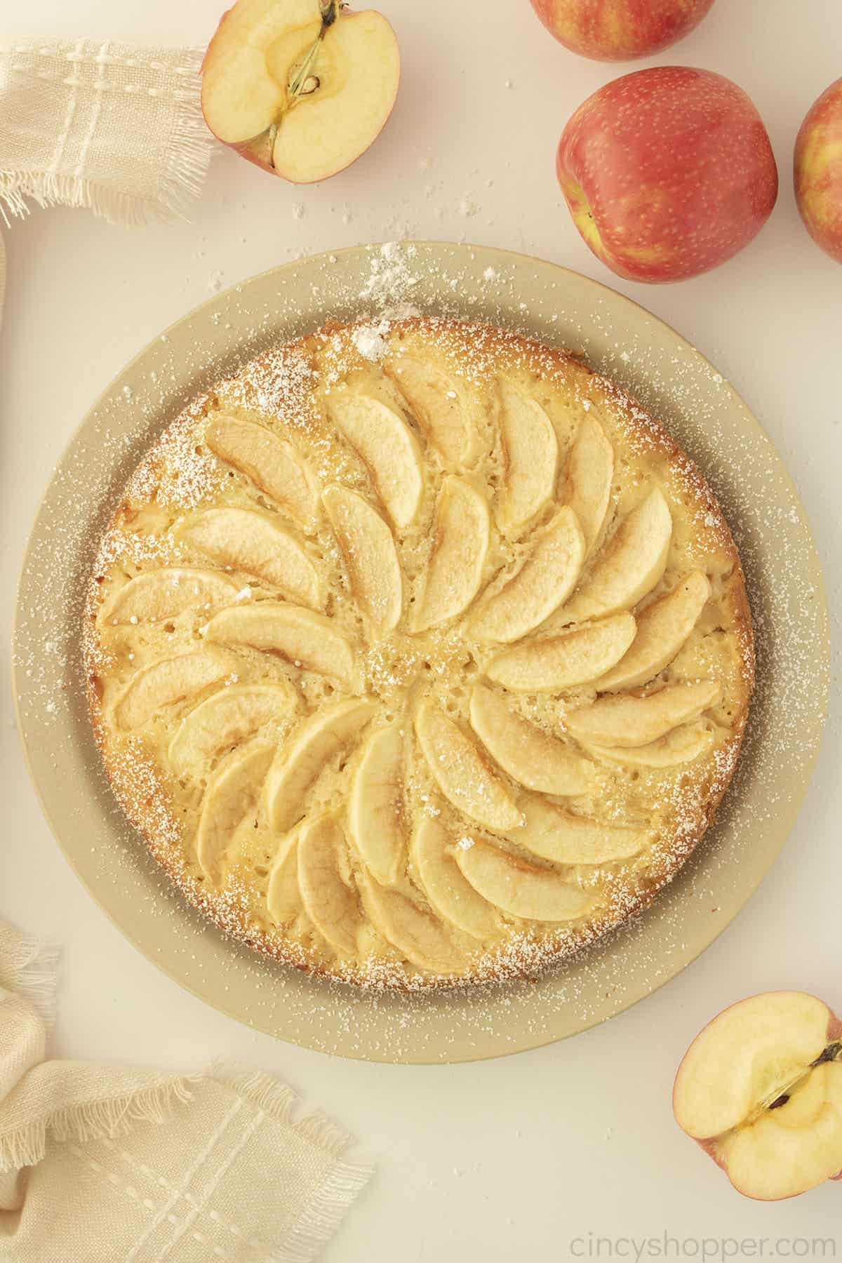 Overhead view of french apple cake on a plate.