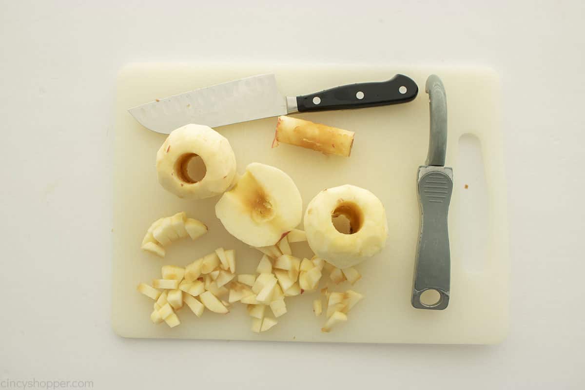 Cored and diced apples on a cutting board.