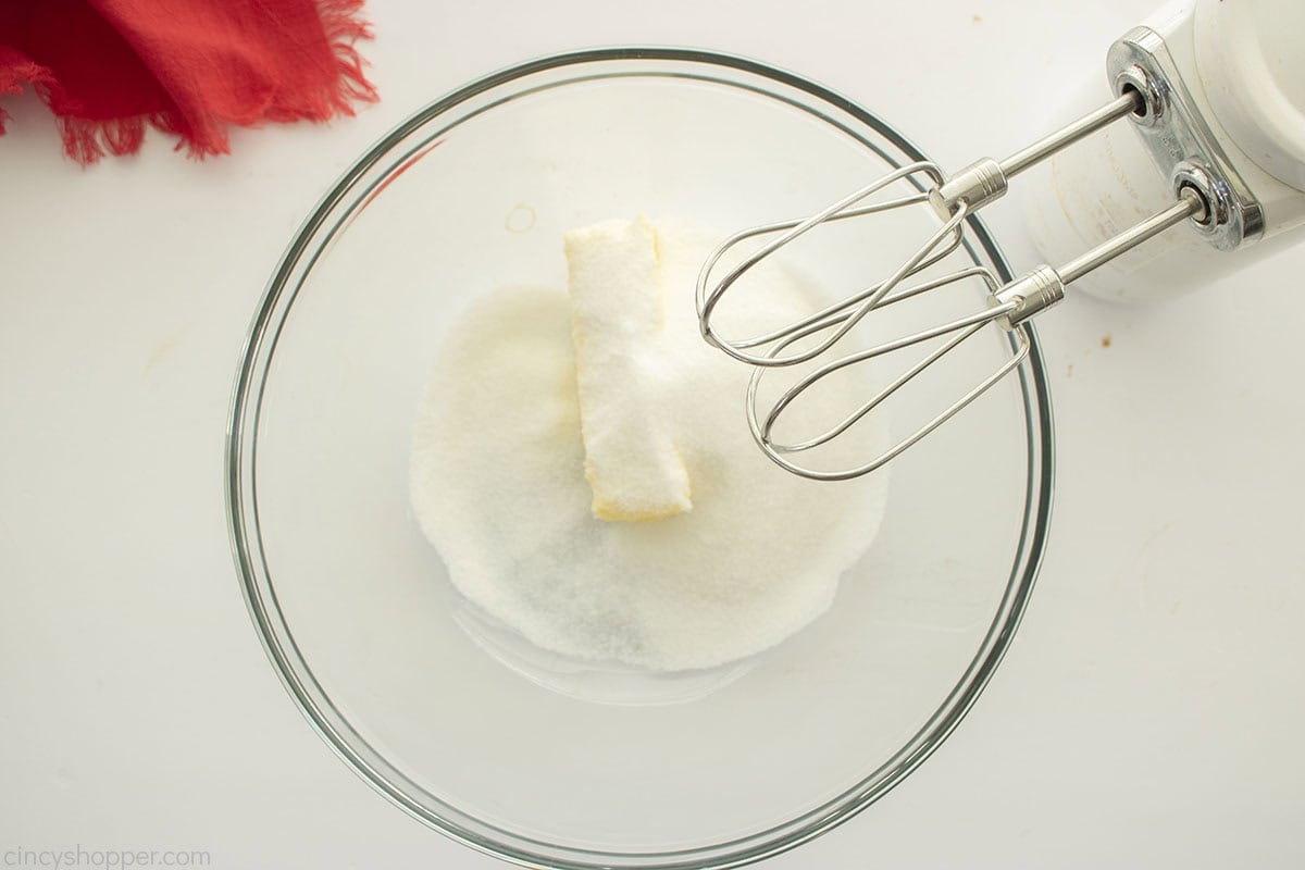 Butter and sugar in a clear bowl.
