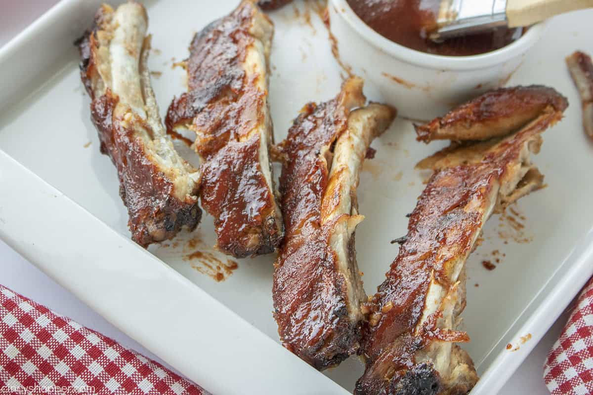 Baby back BBQ oven ribs on a platter.