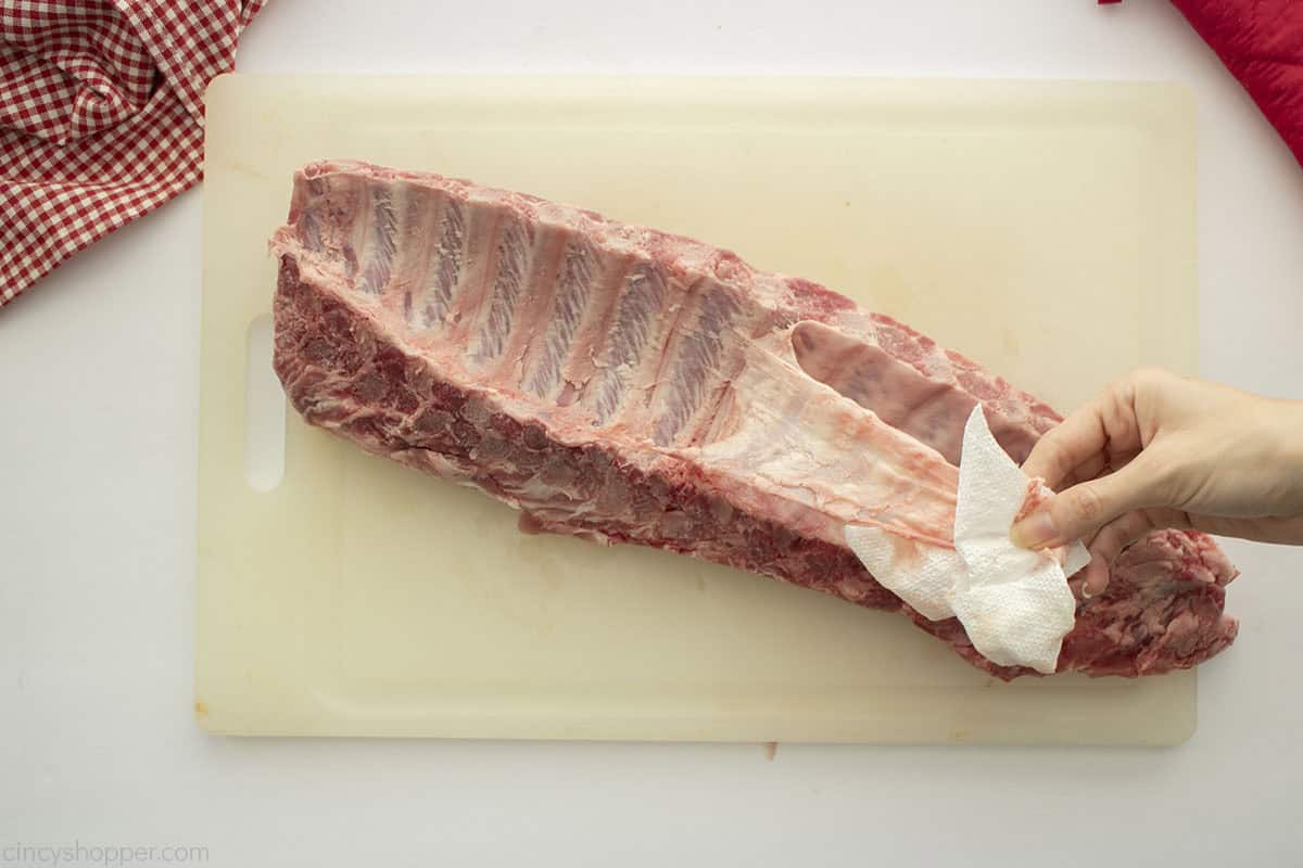 Removing membrane from baby back ribs.